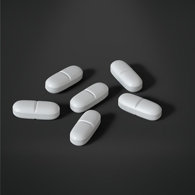 white pills on gray background