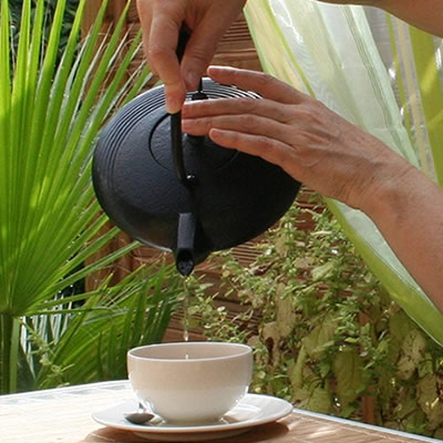 pouring tea from cast-iron teapot