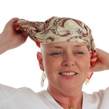 bald female cancer patient with a head scarf