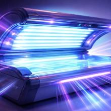 Open tanning bed with lots of light rays shining out